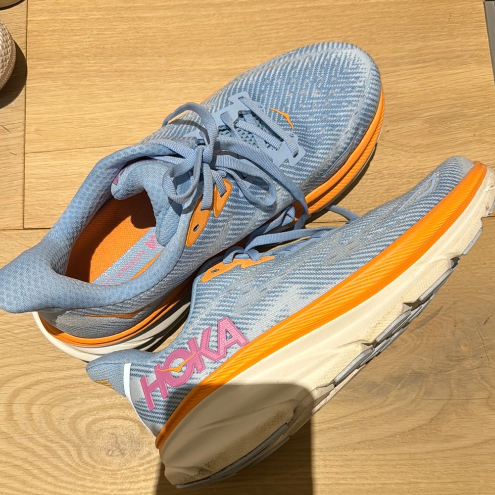 Hoka Blue, Orange, and Purple running sneakers - Clifton 9